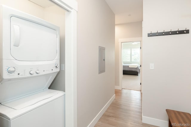 400 Baker Dr Unit Te103, Winter Park, CO 80482 - washroom with stacked washing machine and dryer, light wood finished floors, and electric panel