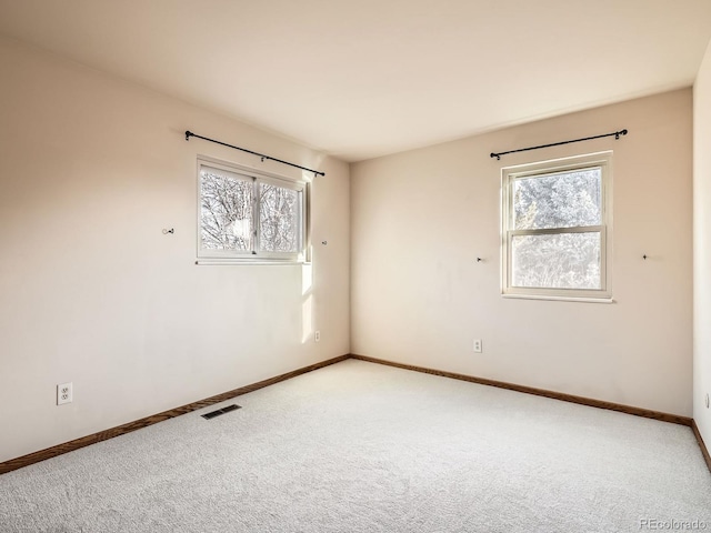 carpeted spare room with plenty of natural light