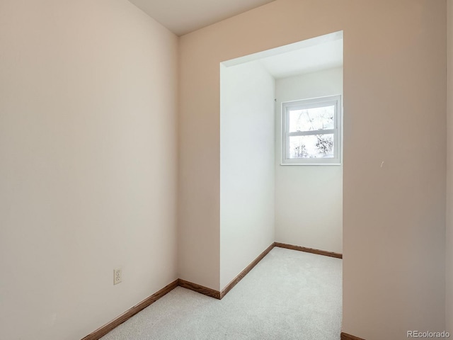 unfurnished room with light carpet