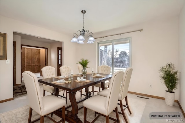 dining space with a chandelier and baseboards