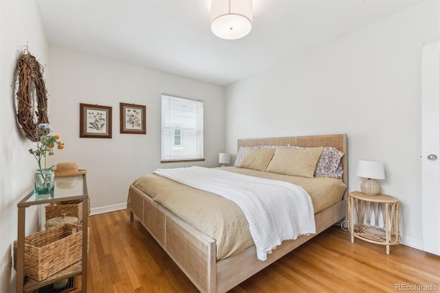 bedroom with light wood-style floors and baseboards