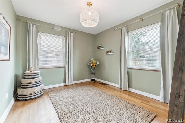 interior space featuring wood finished floors and baseboards