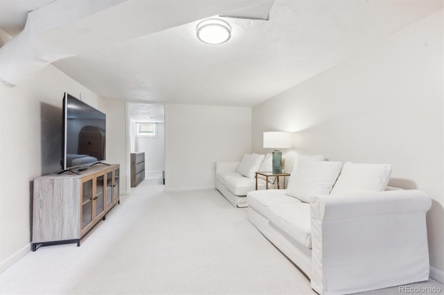 living area with baseboards and carpet floors