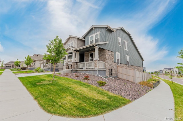 17471 Gandy Dancer Ln, Parker, CO 80134 - view of front of home featuring a porch, stone siding, a front yard, and a residential view