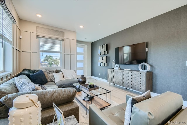 6864 Bryant Ct, Denver, CO 80221 - living room featuring healthy amount of natural light, wood finished floors, baseboards, an accent wall, and recessed lighting