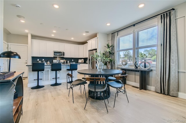 6864 Bryant Ct, Denver, CO 80221 - dining area featuring light wood-style floors and recessed lighting