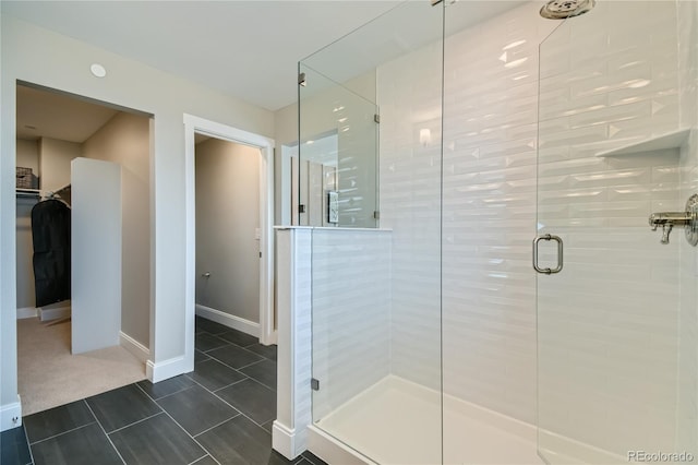 6864 Bryant Ct, Denver, CO 80221 - bathroom with a stall shower, a spacious closet, and baseboards