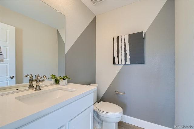 6864 Bryant Ct, Denver, CO 80221 - half bathroom featuring toilet, vanity, and baseboards
