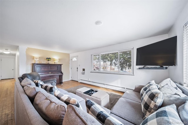 living room featuring a baseboard radiator and light hardwood / wood-style flooring