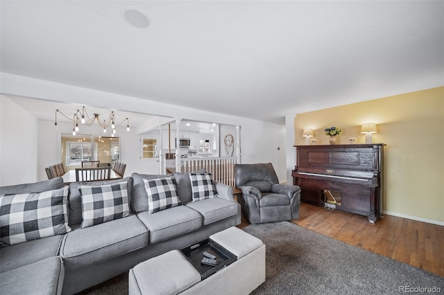 living room with an inviting chandelier and wood-type flooring