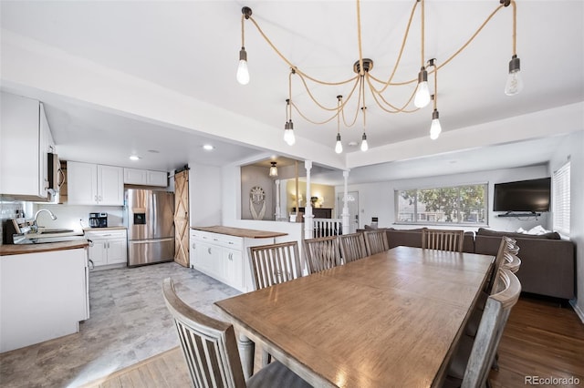 dining space featuring sink and light hardwood / wood-style flooring