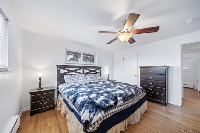 bedroom featuring a baseboard radiator, ceiling fan, and light hardwood / wood-style flooring