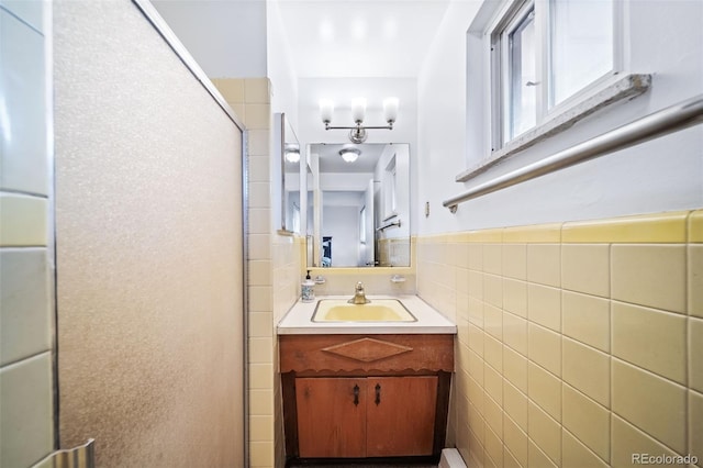 bathroom featuring vanity, tile walls, and walk in shower