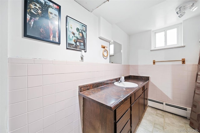 bathroom featuring vanity, a baseboard heating unit, and tile walls