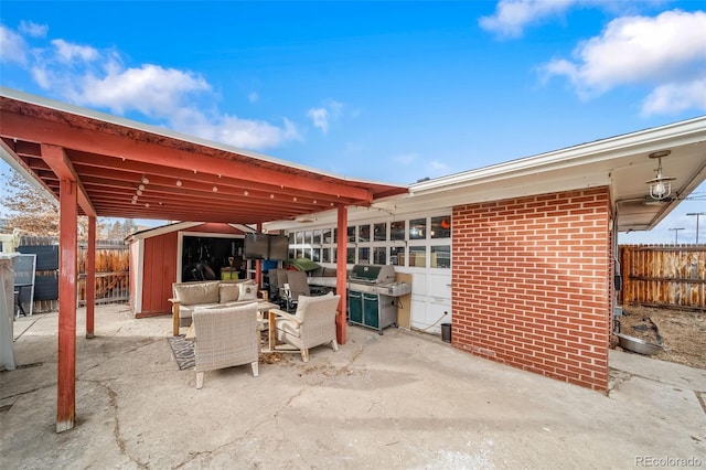 view of patio featuring an outdoor living space, grilling area, and a storage unit