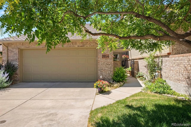 2854 Tenderfoot Hill St, Colorado Springs, CO 80906 - view of front of property featuring concrete driveway, brick siding, and a garage