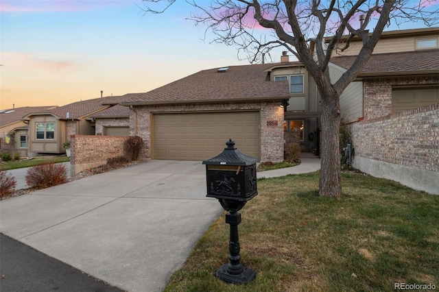 2854 Tenderfoot Hill St, Colorado Springs, CO 80906 - view of front facade featuring brick siding, an attached garage, a shingled roof, and concrete driveway