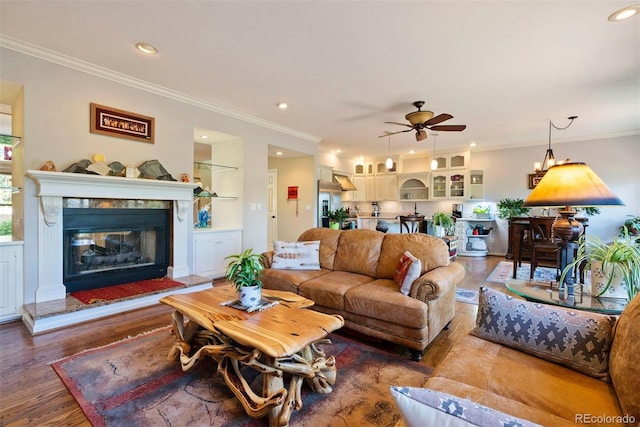 2854 Tenderfoot Hill St, Colorado Springs, CO 80906 - living area with a glass covered fireplace, recessed lighting, crown molding, ceiling fan, and wood finished floors