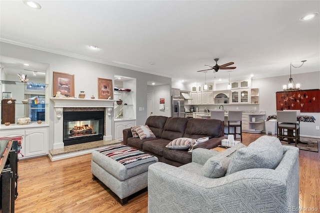 2854 Tenderfoot Hill St, Colorado Springs, CO 80906 - living room featuring ornamental molding, recessed lighting, a multi sided fireplace, light wood-style floors, and ceiling fan with notable chandelier