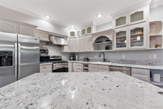 2854 Tenderfoot Hill St, Colorado Springs, CO 80906 - kitchen featuring glass insert cabinets, wall chimney range hood, ornamental molding, appliances with stainless steel finishes, and a sink
