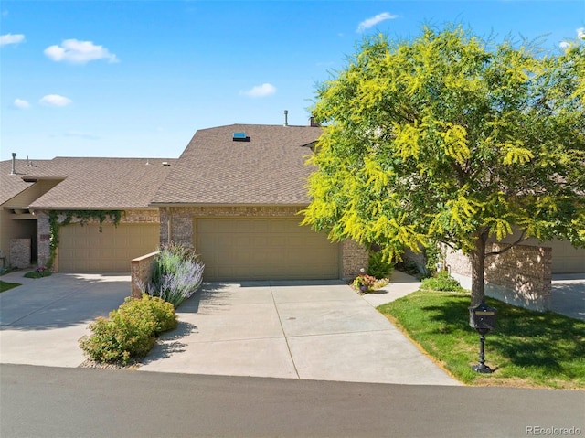 2854 Tenderfoot Hill St, Colorado Springs, CO 80906 - view of front of home with brick siding, roof with shingles, an attached garage, and concrete driveway