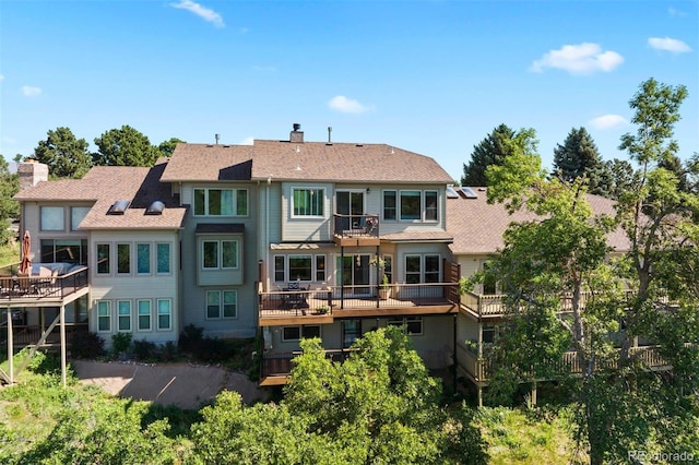 2854 Tenderfoot Hill St, Colorado Springs, CO 80906 - rear view of property with a balcony, a chimney, and a shingled roof