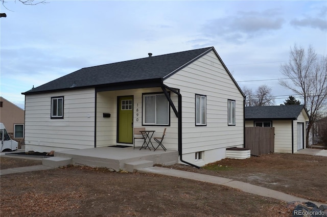 bungalow featuring a garage and covered porch