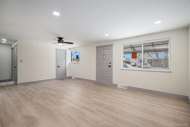 unfurnished living room with ceiling fan and light hardwood / wood-style floors