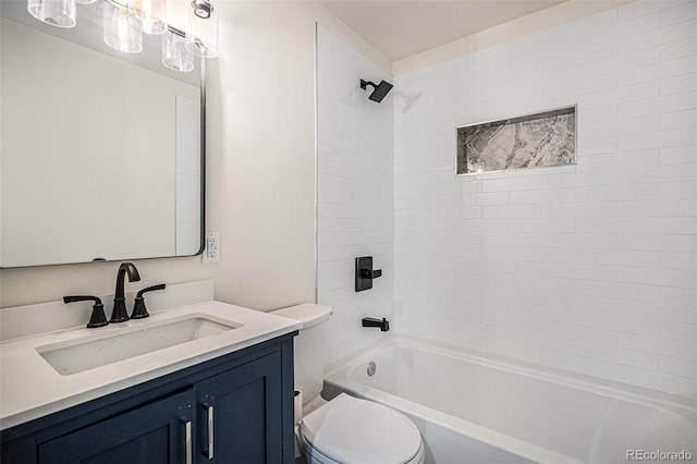 full bathroom with vanity, tiled shower / bath combo, and toilet