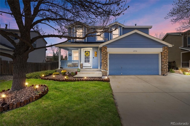 traditional home with driveway, a garage, and stone siding