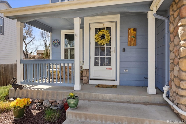view of exterior entry with a porch