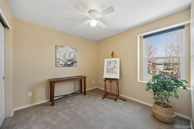 sitting room featuring carpet floors, ceiling fan, and baseboards