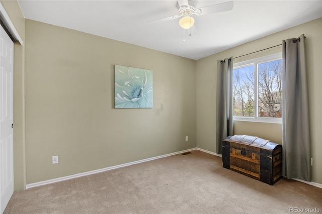 carpeted bedroom with baseboards, ceiling fan, and a closet
