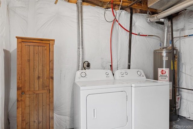 laundry room with gas water heater and washer and dryer