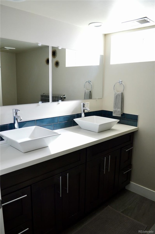 2200 S Cherry St Unit 2216, Denver, CO 80222 - bathroom featuring double vanity, baseboards, and wood finished floors
