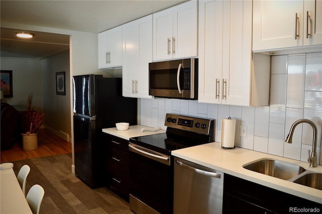 2200 S Cherry St Unit 2216, Denver, CO 80222 - kitchen featuring appliances with stainless steel finishes, a sink, light countertops, and white cabinets