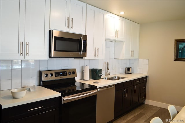 2200 S Cherry St Unit 2216, Denver, CO 80222 - kitchen featuring appliances with stainless steel finishes, a sink, light countertops, white cabinets, and recessed lighting