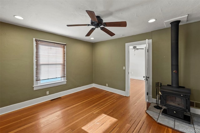 702 E Platte Ave, Colorado Springs, CO 80903 - spare room with a wood stove, hardwood / wood-style floors, baseboards, recessed lighting, and a ceiling fan