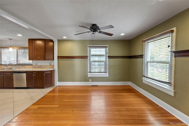 702 E Platte Ave, Colorado Springs, CO 80903 - kitchen with stainless steel dishwasher, healthy amount of natural light, ceiling fan, light wood-style floors, and recessed lighting
