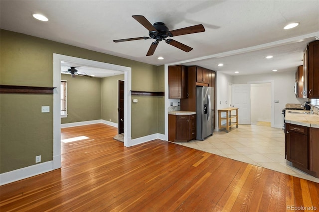 702 E Platte Ave, Colorado Springs, CO 80903 - kitchen featuring appliances with stainless steel finishes, ceiling fan, light countertops, light wood-type flooring, and recessed lighting