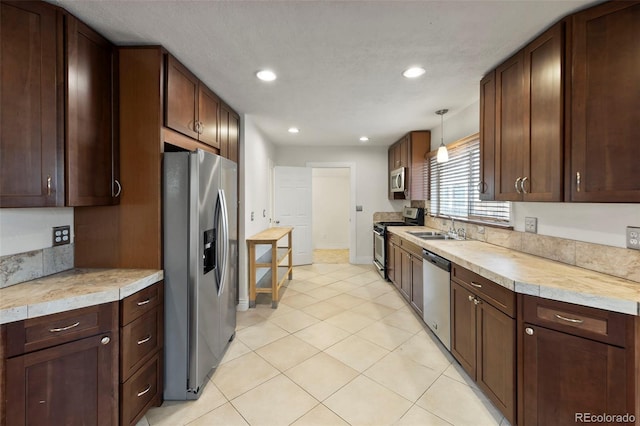 702 E Platte Ave, Colorado Springs, CO 80903 - kitchen featuring appliances with stainless steel finishes, a sink, light countertops, recessed lighting, and light tile patterned floors