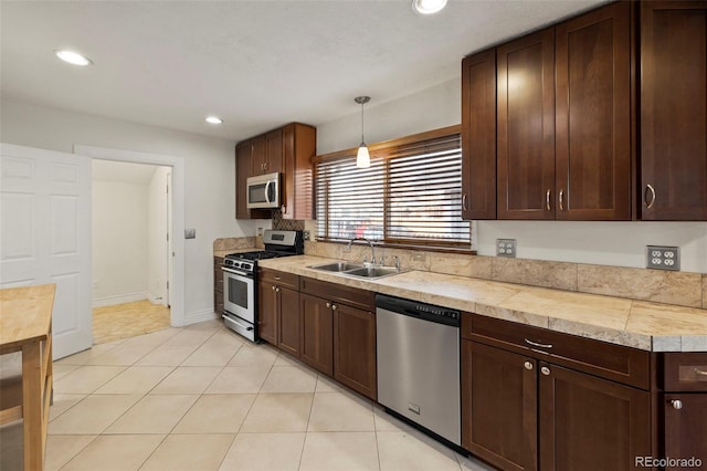 702 E Platte Ave, Colorado Springs, CO 80903 - kitchen featuring appliances with stainless steel finishes, a sink, dark brown cabinets, recessed lighting, and light tile patterned floors