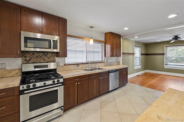 702 E Platte Ave, Colorado Springs, CO 80903 - kitchen featuring appliances with stainless steel finishes, a sink, light countertops, baseboards, and recessed lighting