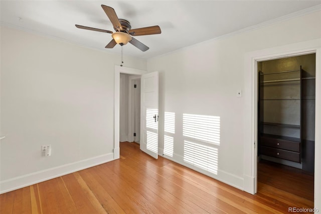 702 E Platte Ave, Colorado Springs, CO 80903 - unfurnished bedroom with baseboards, light wood-style floors, crown molding, a walk in closet, and a closet
