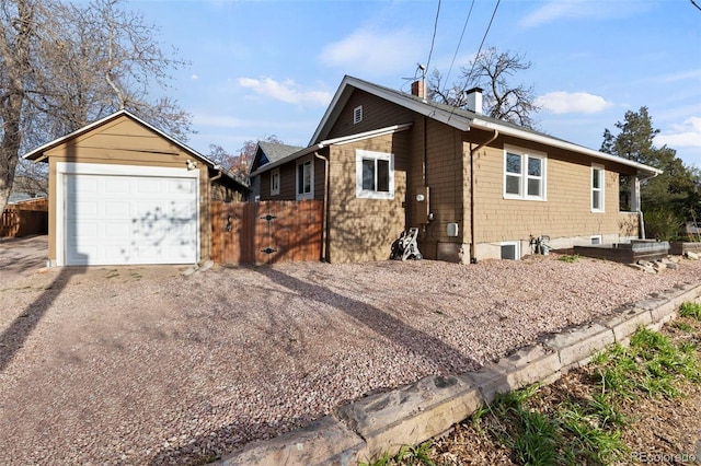 702 E Platte Ave, Colorado Springs, CO 80903 - view of side of property with driveway and a chimney