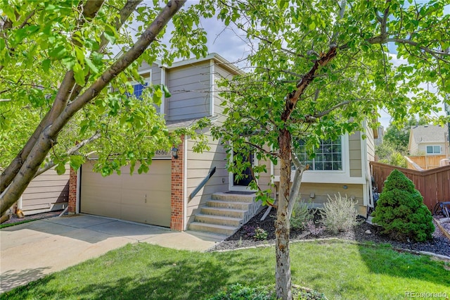 view of front of house featuring a front yard and a garage