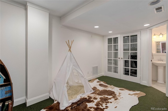 game room with ornamental molding and carpet floors