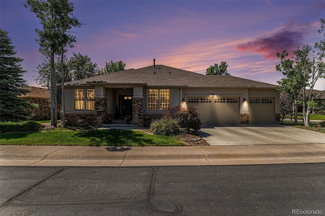 11422 W Cooper Ave, Littleton, CO 80127 - view of front of house featuring a garage, stone siding, driveway, stucco siding, and a yard