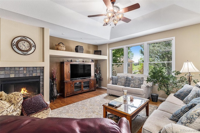 11422 W Cooper Ave, Littleton, CO 80127 - living area with wood finished floors, ceiling fan, a fireplace, and a tray ceiling