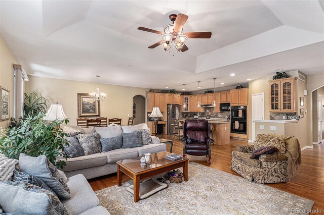 11422 W Cooper Ave, Littleton, CO 80127 - living area featuring arched walkways, a tray ceiling, a chandelier, a ceiling fan, and recessed lighting